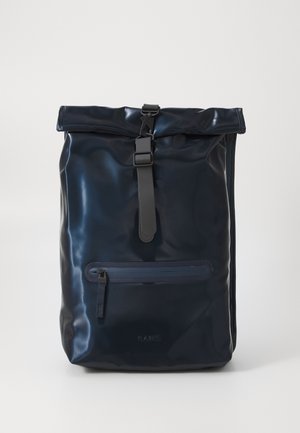 Navy blue waterproof backpack with roll-top closure, front zipper pocket, and adjustable strap, set against a plain white background.