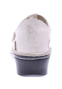 White suede clog with a rounded back, black platform sole, and visible stitching. Features side cutouts for breathability.