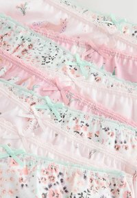 Ridu ridu pastellvärvilisi tüdrukute aluspesu lille- ja loomamustritega, kaunistatud väikeste lipsude ja pitsääristega.