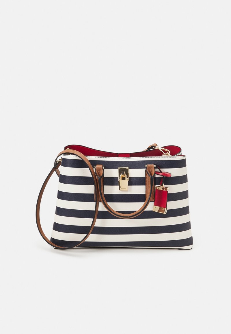 Sac à main rayé bleu marine et blanc avec des poignées en cuir marron, un fermoir doré et un intérieur rouge avec un porte-clés rouge assorti.