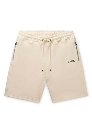 Pantaloni corti beige realizzati in un tessuto morbido, con una cintura elastica dotata di lacci, tasche laterali con zip e un logo sul lato sinistro davanti.