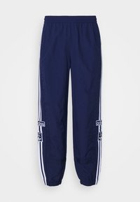Námořnické modré sportovní kalhoty vyrobené z lehkého materiálu, s elastickým pasem, tapered manžetami a bílými bočními pruhy s logy.