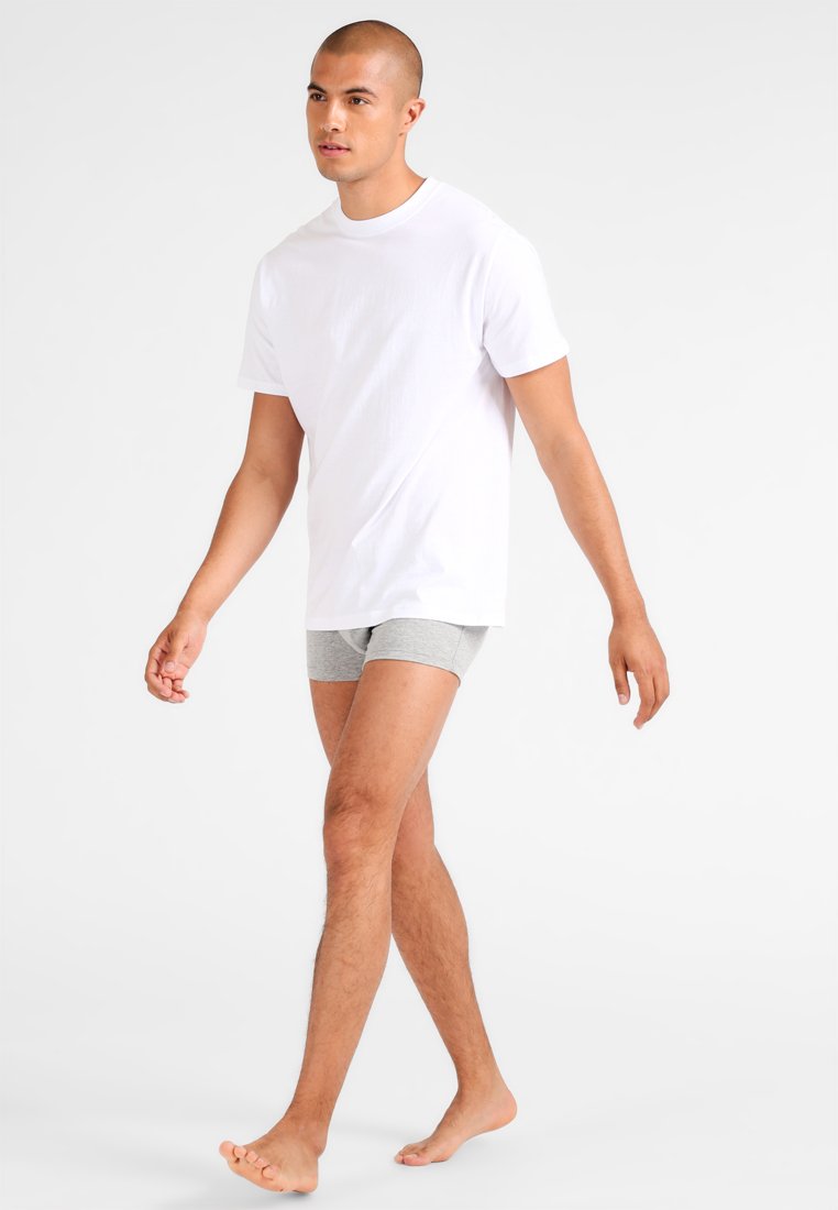 White cotton t-shirt paired with gray boxer briefs. The t-shirt has a classic crew neck and short sleeves; the boxer briefs are fitted.