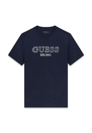 Marineblå bomuldst-shirt med teksten "GUESS" i lyseblå broderi og "EST.1981" nedenunder i en afslappet skrifttype. Kortærmet, rund hals.