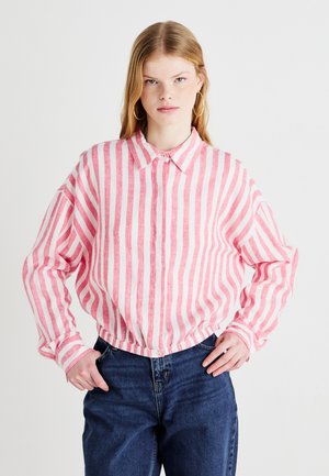 Pink and white striped button-up shirt with a collar, elasticized hem, and long sleeves, made of textured fabric. Casual design.