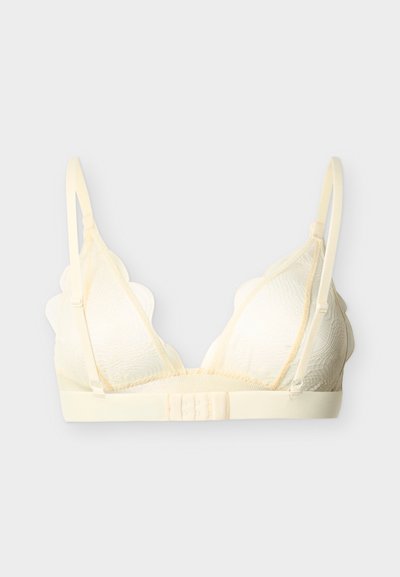 Bralette en dentelle couleur crème avec bretelles fines réglables, bords festonnés sur les bonnets et fermeture à agrafes dans le dos.