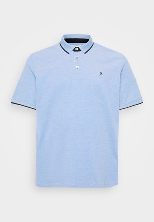 Hellblaues Polohemd mit einer Knopfleiste mit zwei Knöpfen, kontrastierendem dunklem Kragen und Saumakzenten. Weiches Baumwollgewebe mit einer strukturierten Oberfläche.