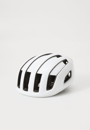 Casque de cyclisme blanc avec plusieurs fentes de ventilation, surface lisse et design aérodynamique. Accents en matériau sombre le long des bords.