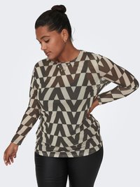 Long-sleeve top in semi-sheer fabric featuring a geometric brown and cream zigzag pattern, paired with black pants.