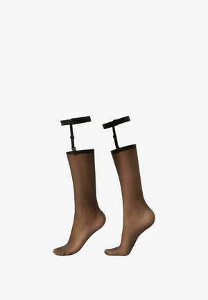 Bas résilles noires transparentes jusqu'aux genoux avec des bords élastiques et des bretelles ajustables. Texture lisse, design avec pied, et teinte marron clair.