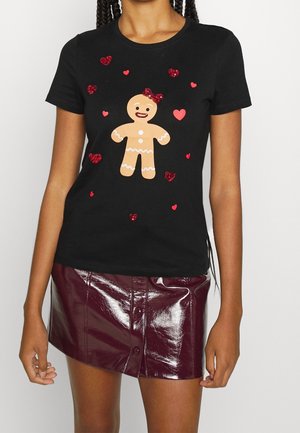 Black short-sleeve shirt with smiling gingerbread figure and red glitter hearts, worn with shiny burgundy button-front mini skirt.