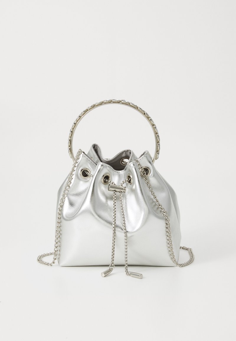 Metallisch silberne Bucket-Bag mit einem Schlaufenhenkel, Kettenakzenten und Zugverschluss. Weiches Material mit glatter Textur und strukturiertem Design.