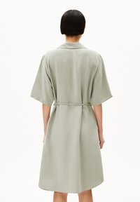 Light green, knee-length robe with a collar, short sleeves, and a tie belt. Smooth texture, simple design, and no visible patterns or embellishments.