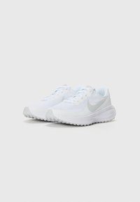 White athletic shoes with a mesh upper and light gray accents. Features a round toe, flat laces, and textured soles for grip.