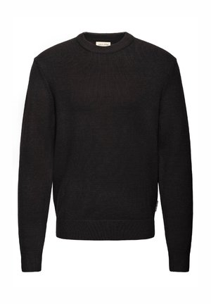 Černý svetr s žebrovaným pleteným vzorem, s kulatým výstřihem, dlouhými rukávy a přiléhavým lemem. Minimalistické značení na boku.
