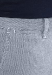 Gray denim pants with a textured finish, featuring a visible waistband, belt loops, and a single top-stitched pocket on the front.