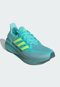 Lightweight athletic shoe with a teal mesh upper, bright green accents, and textured outsole. Features three-stripe branding and "Light Boost" detail.