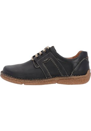 Scarpa in pelle nera con cuciture beige, punta rotonda e suola in gomma marrone testurizzata. Presenta un pannello laterale decorativo e chiusura con lacci.