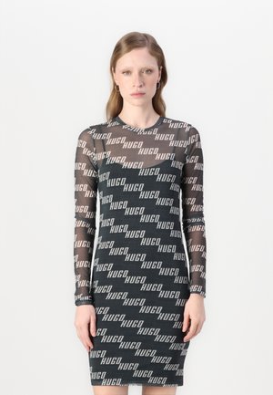 Long-sleeve dress made of sheer black fabric featuring a repeating logo pattern in light gray and white, fitted silhouette, crew neckline.
