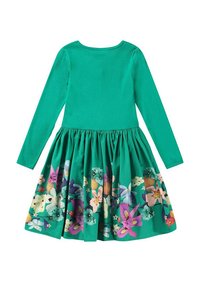 Långärmad klänning med en enfärgad grön topp och en full kjol med blommönster i olika färger, inklusive lila, rosa och vitt.