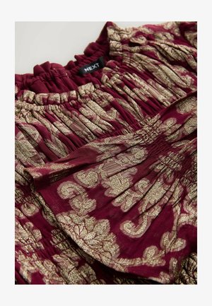 Bordeauxkleurige blouse met een gouden bloemmotief, voorzien van een elastische halslijn met plooien. Etiket zichtbaar: NEXT.