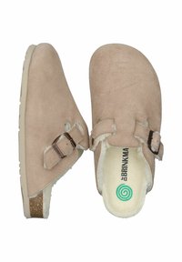 Beige suede clogs with a rounded toe, adjustable strap, soft inner lining, and a textured rubber sole featuring a subtle cork accent.