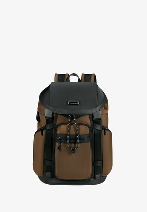 Brown and black backpack with a structured shape, multiple zippered pockets, durable fabric, and adjustable straps. Rope pull accent detail.