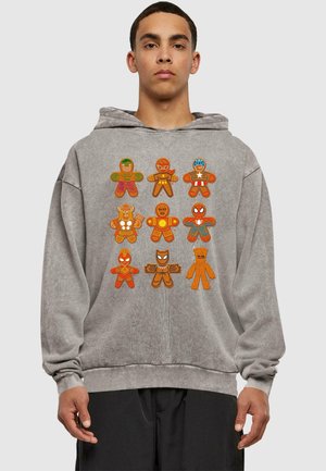 Felpa grigia con capuccio caratterizzata da figure di pan di zenzero colorate e in stile cartone animato che rappresentano vari supereroi, esposte in modo evidente sul davanti.