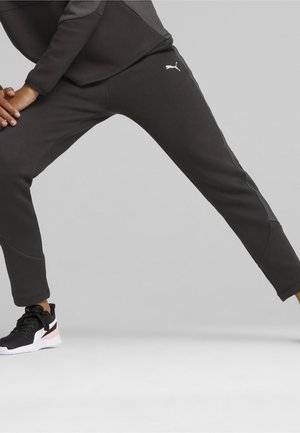 Dunkelgraue Sporthose mit figurnahem Design, gerippten Akzenten und einem weißen Logo an der Seite. Geeignet für aktive Freizeitbekleidung.