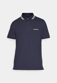 Polo shirt blu navy in cotone, con colletto a righe bianche, due bottoni e una toppa con logo sul lato sinistro del petto.