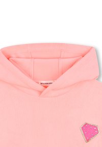 Felpa a coste rosa con cappuccio. Presenta una patch decorativa a forma di gemma in rosa con accenti luccicanti. Tessuto morbido al tatto. Branding visibile.