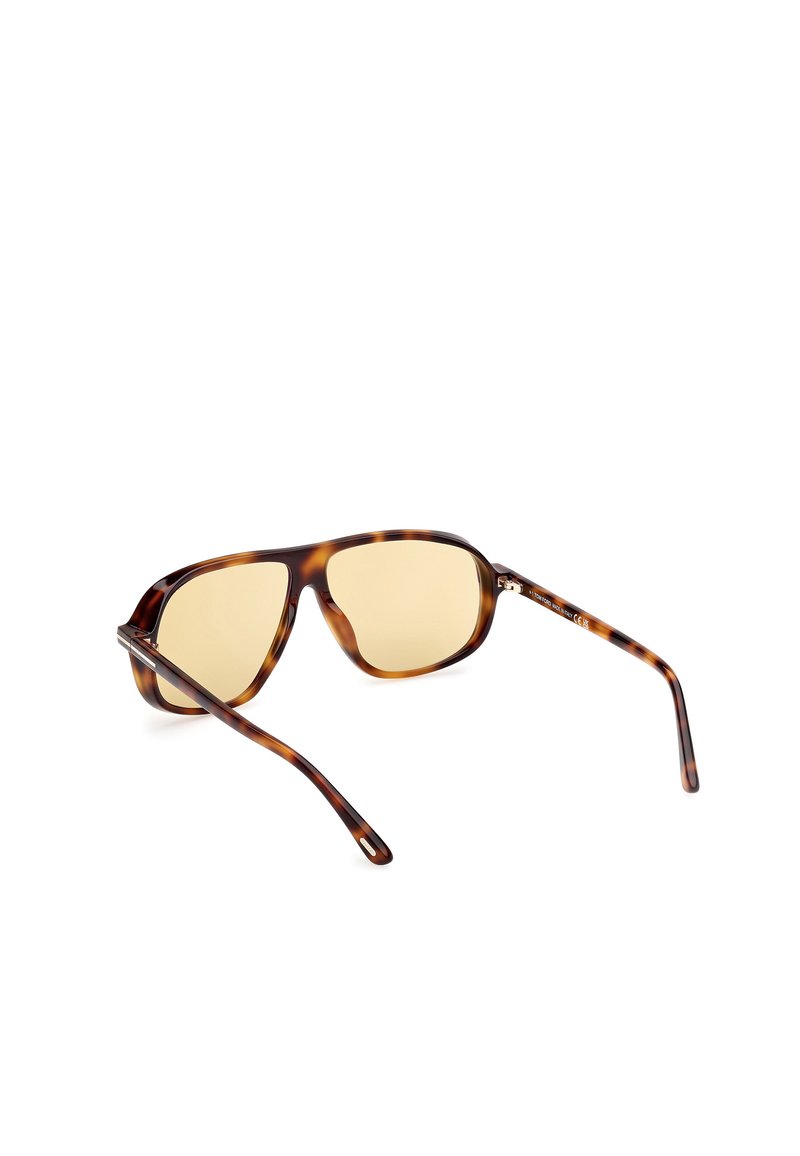 Occhiali da sole tartaruga con lenti di colore marrone, montatura quadrata e aste sottili con dettagli metallici argentati. Rivestimento anti-riflesso.