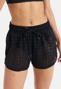 Black sports shorts with a textured open weave pattern, elastic waistband, and adjustable drawstring. Features a loose fit with side seams.