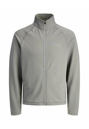 Lys grå zip-up jakke med høj krave, lavet af struktureret stof. Har logoet "CNZ" på øverste venstre side.