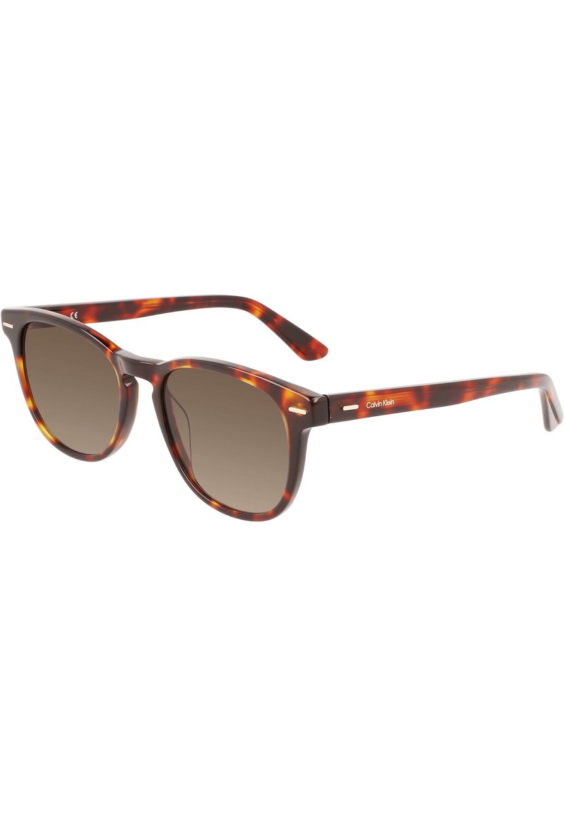 Schildkrötensonnenbrille mit braunen Verlaufslinsen, runder Form und schlankem, poliertem Design. Verfügt über dünne Bügel mit Branding-Detail.