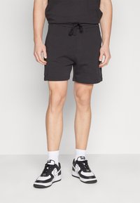 Tommy Jeans BADGE CARGO  - Tracksuit bottoms - black