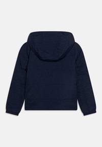 Navy puffer jacket with a hood, featuring a quilted texture and elastic cuffs. The back displays horizontal stitching lines.