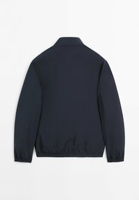 Marineblaue, leichte Jacke mit elastischen Bündchen und Bund, flach von hinten auf weißem Hintergrund präsentiert.