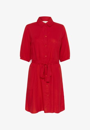 Piros ingruha, galléros nyakkal, rövid puffasztott ujjal, elöl gombos záródással és derékban passzoló övvel. Simább szövettextúra.