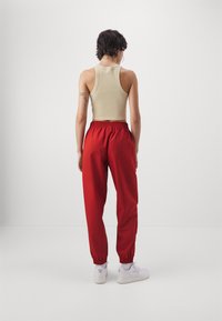 Jordan CORE - Pantalones deportivos - dune red