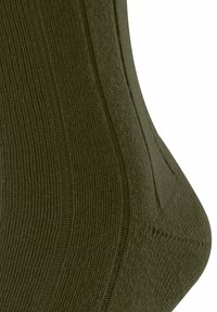 Calzino verde oliva con texture a coste, una vestibilità aderente e rinforzo nel tallone e nella punta, che presenta un design semplice e materiale morbido.