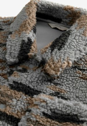 Textured gray, black, and brown jacket with a plush, fleece-like material. Notable details include a collar and button closure.