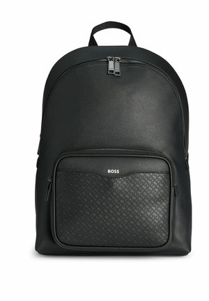 Black leather backpack with a smooth texture, featuring a front zippered pocket with a pattern, and dual top zippers. Logo displayed on pocket.