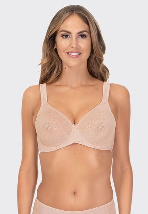 Lace-trimmed beige bra with underwire support. Features adjustable straps and a bow accent at the center. Soft fabric texture.