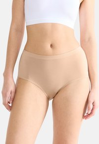 Ljust beige högmidjade underkläder med en mjuk textur och elastisk midjeband, designade för komfort och full täckning.