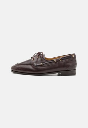 Brown leather loafers with a structured design, gold eyelets, and laces. Features a low heel and detailed stitching along the vamp.