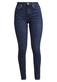 Jeans de tiro alto y corte slim en denim azul oscuro con costuras en contraste y un diseño de cinco bolsillos. Cuenta con cierre frontal de botón y cremallera.