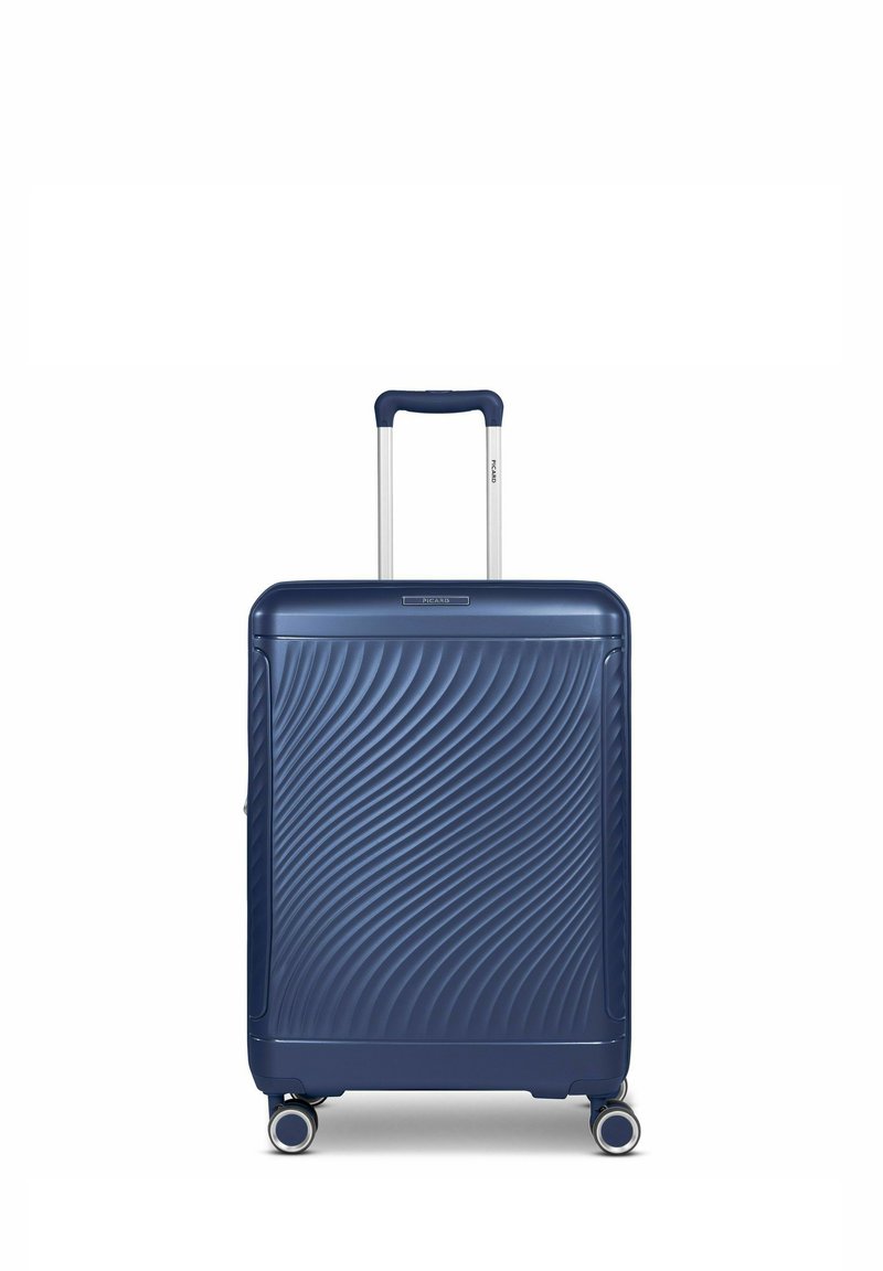 Maleta rígida de color navy con una superficie texturizada ondulada, mango telescópico y cuatro ruedas, diseñada para ofrecer durabilidad y movilidad.