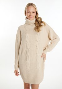 Rochie tricotată bej, cu guler înalt, având modele texturate și detalii din tricot cu sfoară, cu o croială lejeră și manșete cu nervuri.