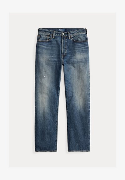 Traperice plavih nijansi opuštenog kroja s izblijedjelim završetkom, vidljivim tragovima habanja, ravnim krojem i tradicionalnim zatvaranjem na gumbe.